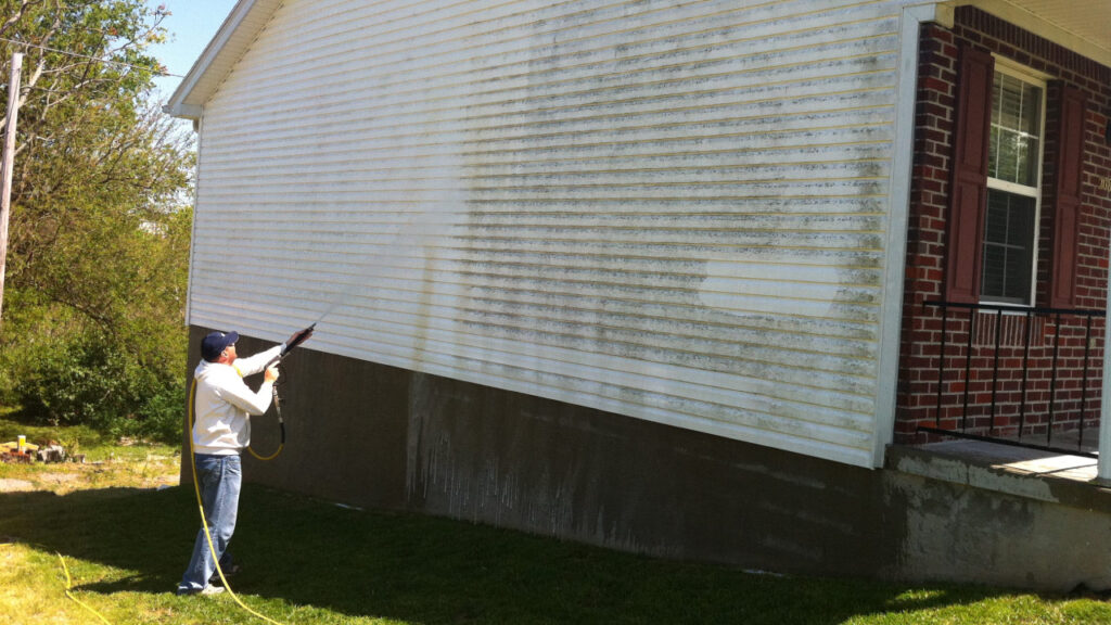 Technician Cleaning Vinyl Siding